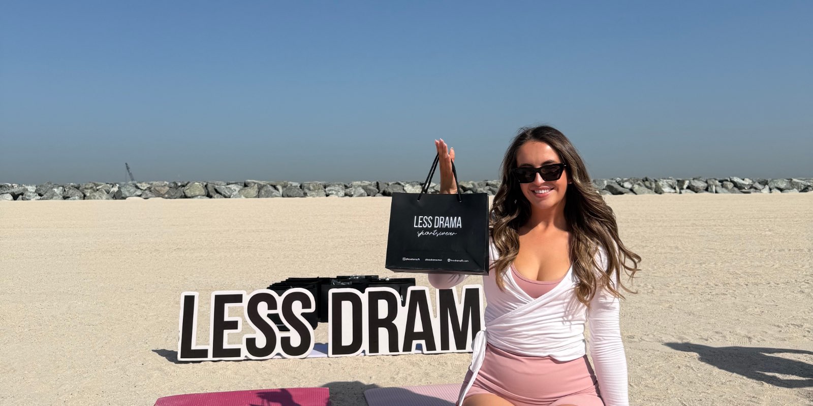 A guest with a Less Drama gift bag at the Beach Pilates Dubai brand collaboration event