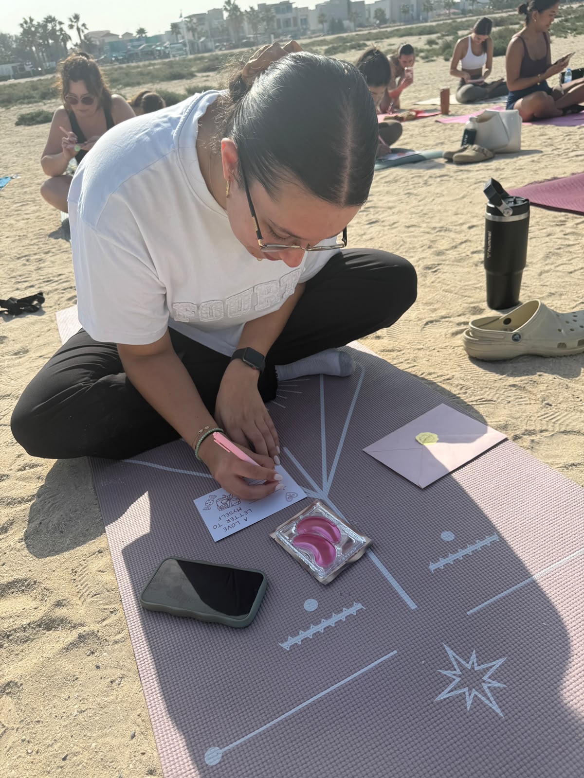 Galentine's beach Pilates event with guided postcard writing in Dubai
